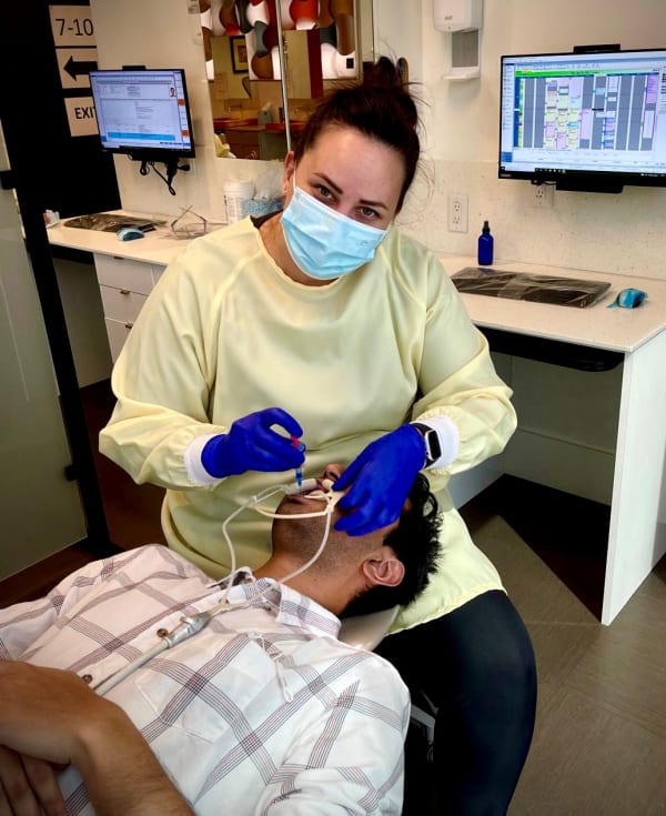 A team member at South Surrey Smiles works on a patient.